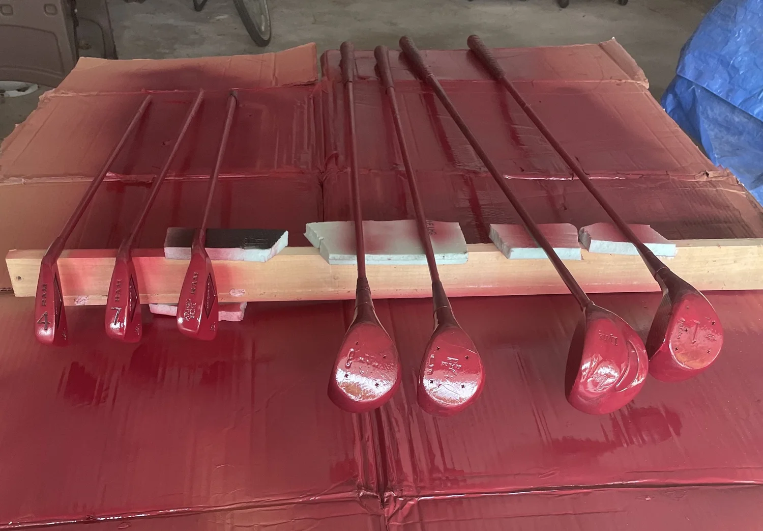Hand-painted red golf clubs during finishing